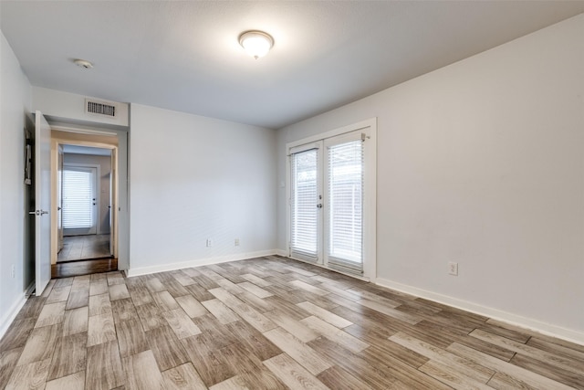 5816 Birchbrook Dr Unit 122, Dallas, TX 75206 - unfurnished room featuring light wood-style flooring and a smoke detector
