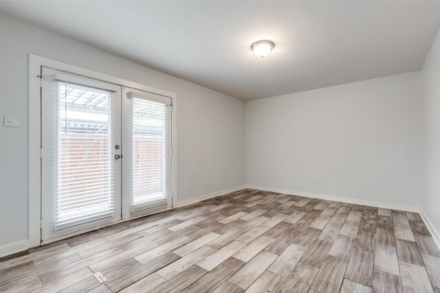 5816 Birchbrook Dr Unit 122, Dallas, TX 75206 - unfurnished room with light wood-type flooring and french doors