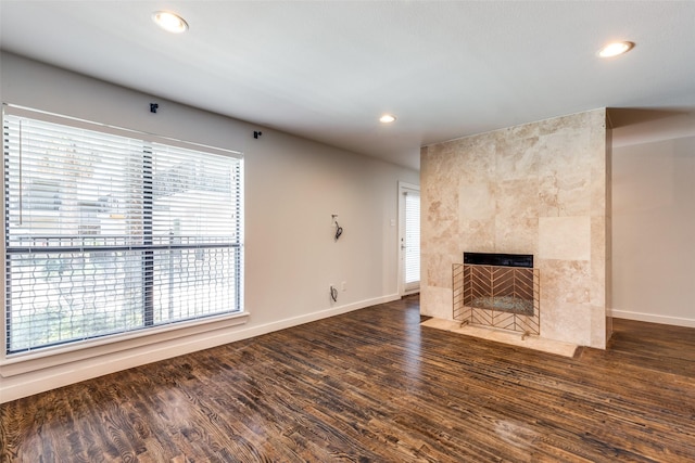 5816 Birchbrook Dr Unit 122, Dallas, TX 75206 - unfurnished living room featuring recessed lighting, wood finished floors, and a tiled fireplace