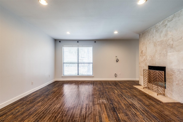 5816 Birchbrook Dr Unit 122, Dallas, TX 75206 - unfurnished living room with wood finished floors, a tiled fireplace, and recessed lighting