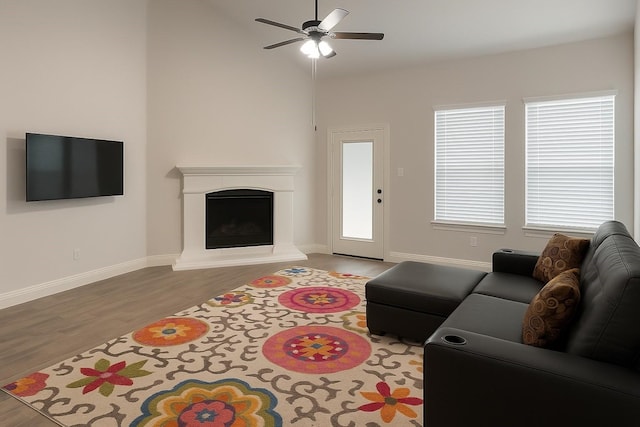 617 Saragosa Ct, Mckinney, TX 75071 - living room featuring wood finished floors, a fireplace with raised hearth, and a ceiling fan