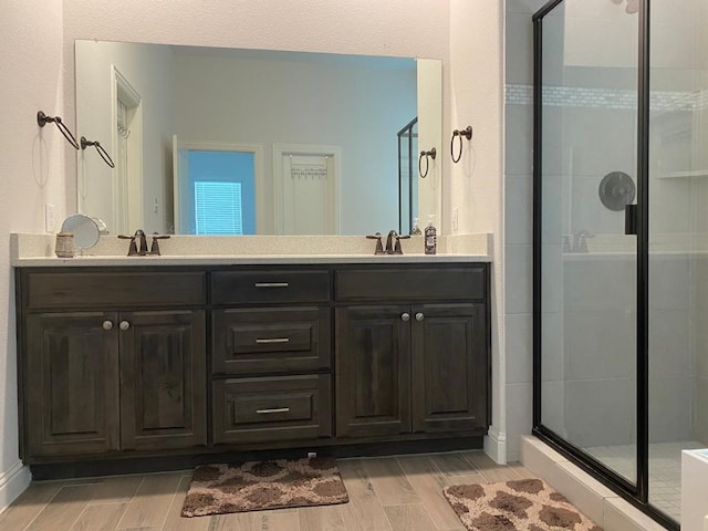 617 Saragosa Ct, Mckinney, TX 75071 - bathroom featuring wood finished floors, a shower stall, and double vanity