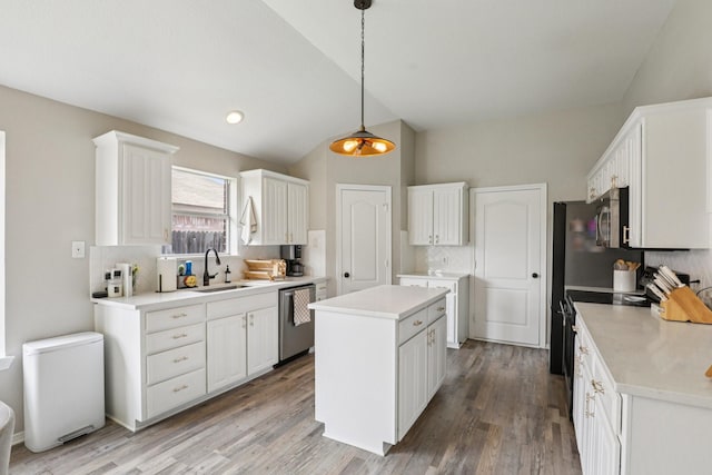 6932 Lomo Alto Dr, Fort Worth, TX 76132 - kitchen featuring lofted ceiling, appliances with stainless steel finishes, tasteful backsplash, a kitchen island, and white cabinets