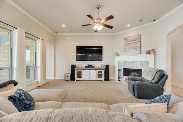 11088 Whispering Ln, Talty, TX 75126 - carpeted living room featuring arched walkways, ornamental molding, a fireplace, a ceiling fan, and recessed lighting