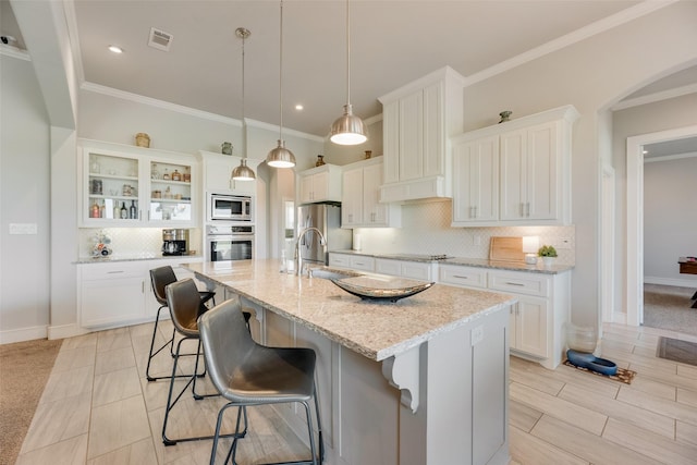 11088 Whispering Ln, Talty, TX 75126 - kitchen featuring stainless steel appliances, backsplash, a breakfast bar, white cabinetry, and ornamental molding