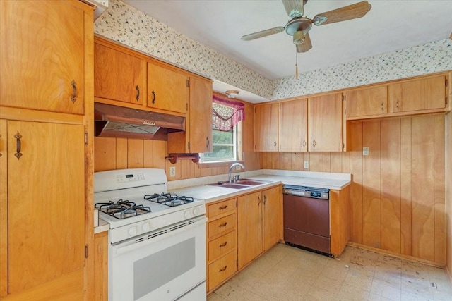 509 Lipscomb St, Bonham, TX 75418 - kitchen with white gas range, dishwashing machine, under cabinet range hood, light flooring, and light countertops