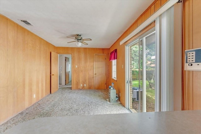 509 Lipscomb St, Bonham, TX 75418 - carpeted spare room with a ceiling fan and wooden walls