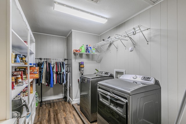 3401 Medallion Cir, Waco, TX 76706 - washroom featuring washing machine and clothes dryer, wood finished floors, a textured ceiling, and attic access