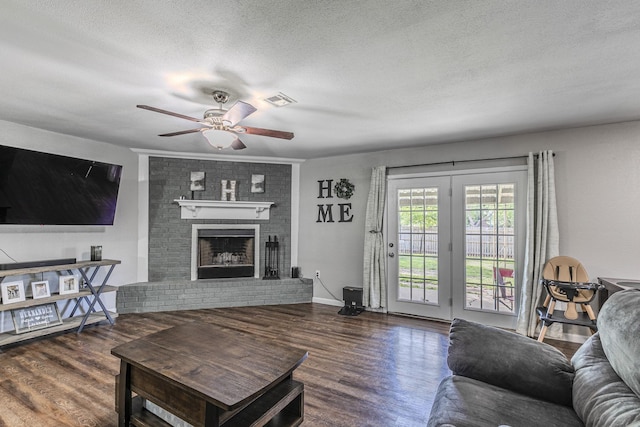 3401 Medallion Cir, Waco, TX 76706 - living area featuring a ceiling fan, wood finished floors, a textured ceiling, and a fireplace