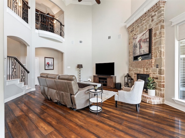 2 Pond View Ct, Mansfield, TX 76063 - living room with hardwood / wood-style flooring, stairs, a glass covered fireplace, a high ceiling, and ceiling fan