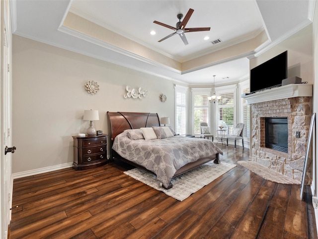 2 Pond View Ct, Mansfield, TX 76063 - bedroom featuring wood finished floors, a raised ceiling, a chandelier, ornamental molding, and a stone fireplace