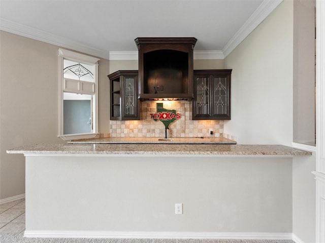 2 Pond View Ct, Mansfield, TX 76063 - kitchen with dark brown cabinetry, tasteful backsplash, glass insert cabinets, crown molding, and light stone counters