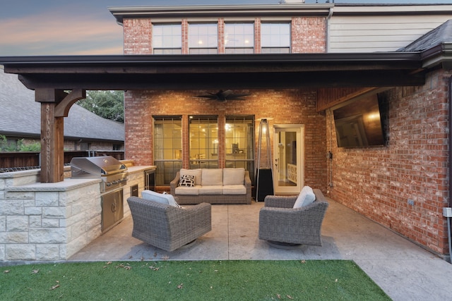 2778 Hidden Knoll Trl, Frisco, TX 75034 - patio terrace at dusk with an outdoor kitchen, ceiling fan, a patio area, and an outdoor hangout area