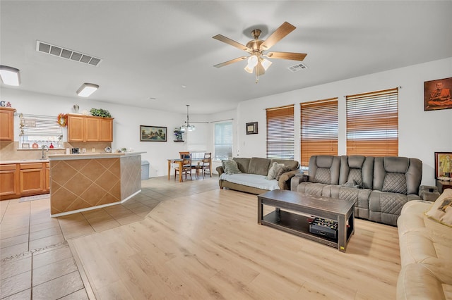 5805 Cobalt Ln, Killeen, TX 76542 - living area with a ceiling fan, light wood finished floors, and a chandelier