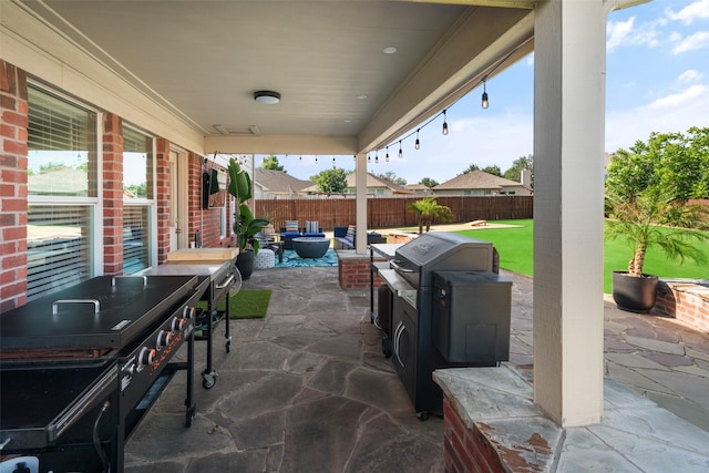 2115 Highland River Dr, Wylie, TX 75098 - fenced backyard featuring grilling area and a patio