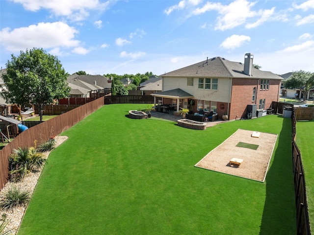 2115 Highland River Dr, Wylie, TX 75098 - back of property featuring a fire pit, a fenced backyard, brick siding, and a patio area