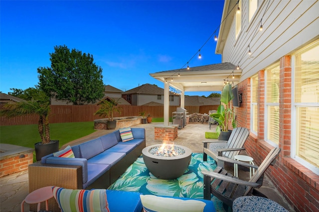 2115 Highland River Dr, Wylie, TX 75098 - fenced backyard with a patio area and an outdoor living space with a fire pit