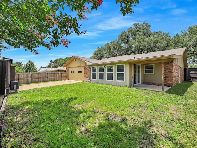 2032 Christie Ln, Carrollton, TX 75007 - rear view of house with a garage, concrete driveway, a patio, a fenced backyard, and board and batten siding