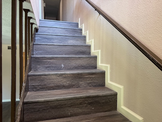 711 Ticonderoga Dr, Garland, TX 75043 - stairs featuring a textured wall and baseboards