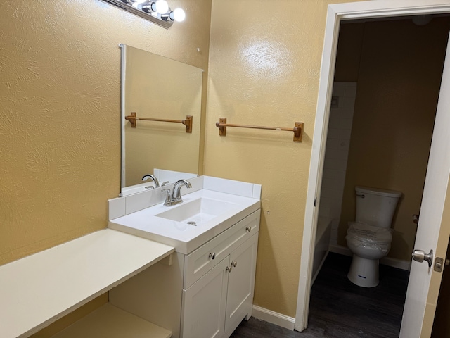 711 Ticonderoga Dr, Garland, TX 75043 - full bathroom with vanity, wood finished floors, and a textured wall