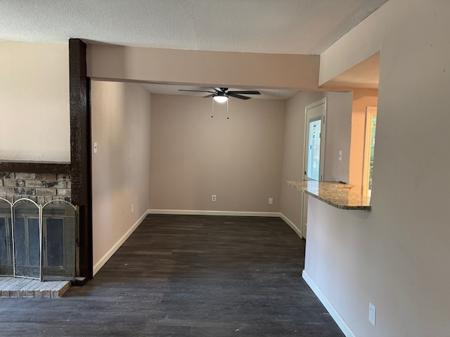 711 Ticonderoga Dr, Garland, TX 75043 - unfurnished living room with ceiling fan, a fireplace, and wood finished floors