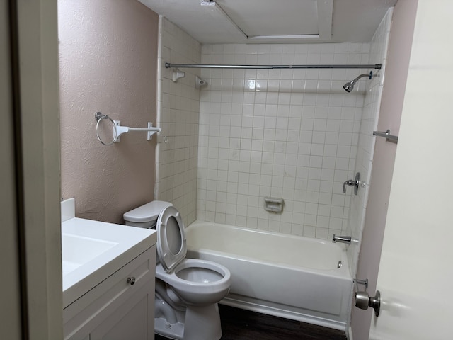 711 Ticonderoga Dr, Garland, TX 75043 - bathroom with vanity, bathing tub / shower combination, wood finished floors, and a textured wall