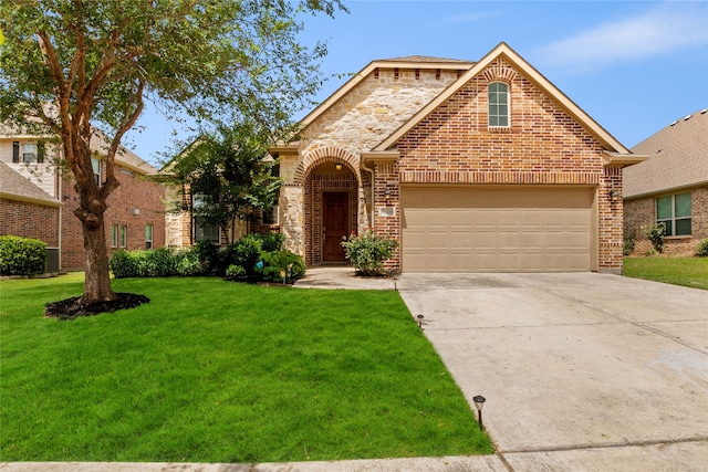 3408 Glen Crest Ln, Denton, TX 76208 - view of front of house featuring a front yard, driveway, brick siding, and an attached garage