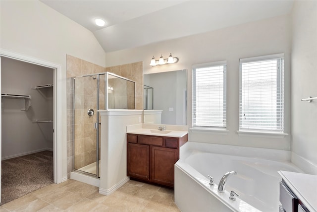 3408 Glen Crest Ln, Denton, TX 76208 - full bathroom featuring a shower stall, a bath, a walk in closet, vanity, and vaulted ceiling