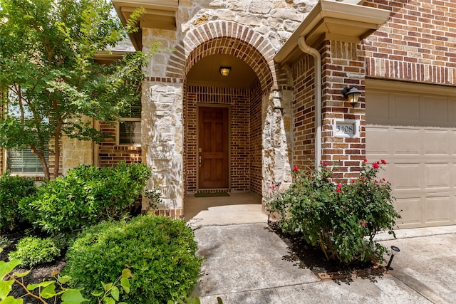 3408 Glen Crest Ln, Denton, TX 76208 - property entrance with brick siding, a garage, and stone siding