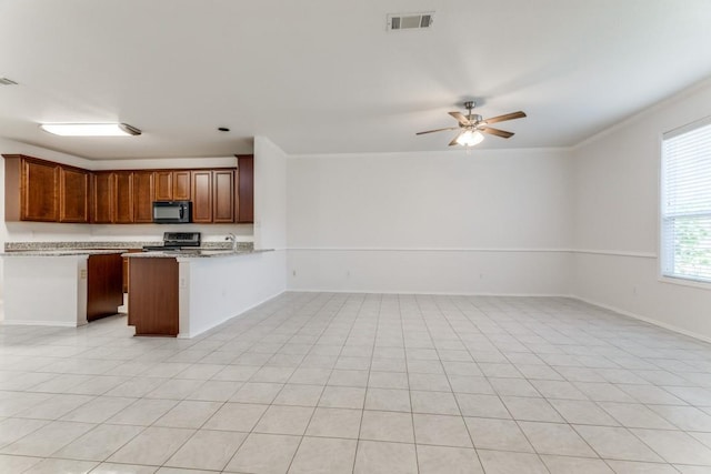 4908 Blue Top Dr, Fort Worth, TX 76179 - kitchen with black microwave, open floor plan, electric range, a ceiling fan, and ornamental molding