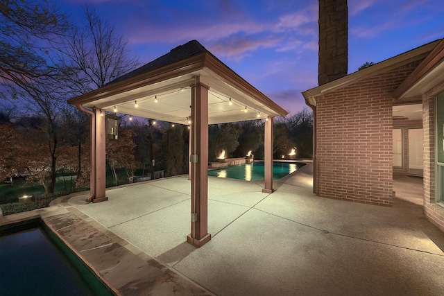 149 Silver Valley Ln, Fort Worth, TX 76108 - patio terrace at dusk with an outdoor pool, a gazebo, and a patio