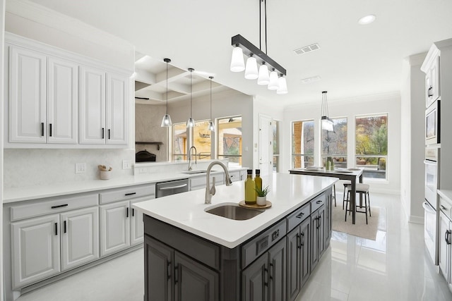 149 Silver Valley Ln, Fort Worth, TX 76108 - kitchen with stainless steel appliances, white cabinetry, crown molding, coffered ceiling, and pendant lighting