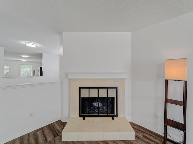 2321 Live Oak Dr, Little Elm, TX 75068 - detailed view of wood finished floors, a tile fireplace, and fridge