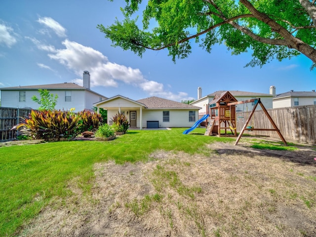 2321 Live Oak Dr, Little Elm, TX 75068 - back of property with a playground and a fenced backyard