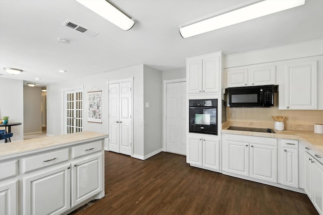 200 Arcadia St, Hurst, TX 76053 - kitchen with black appliances, decorative backsplash, dark wood-type flooring, white cabinetry, and light countertops