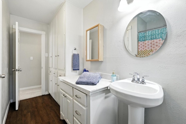 200 Arcadia St, Hurst, TX 76053 - bathroom featuring wood finished floors and baseboards