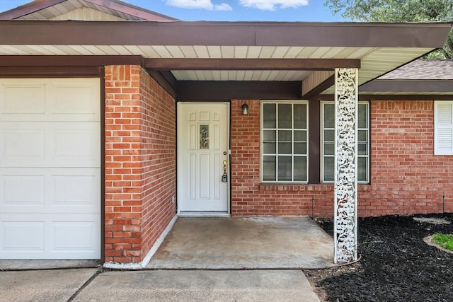 200 Arcadia St, Hurst, TX 76053 - property entrance featuring brick siding, an attached garage, and roof with shingles