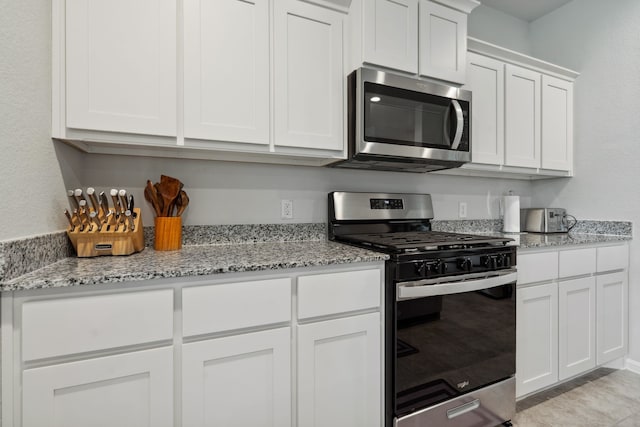 5912 Piedrosa Ct, Denton, TX 76226 - kitchen featuring appliances with stainless steel finishes, white cabinets, and light stone countertops