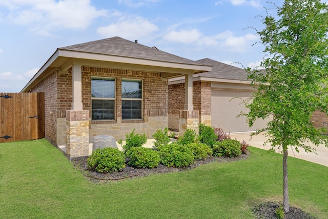 5912 Piedrosa Ct, Denton, TX 76226 - view of front facade with an attached garage, concrete driveway, brick siding, a shingled roof, and a gate