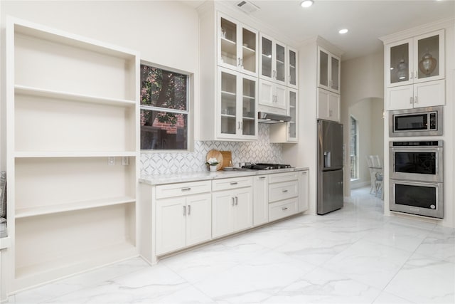 6608 Terrace Mill Ln, Plano, TX 75024 - kitchen with stainless steel appliances, light marble finish floors, tasteful backsplash, recessed lighting, and arched walkways