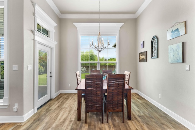 10309 Creekside Ln, Waco, TX 76712 - dining space featuring a chandelier, wood finished floors, ornamental molding, and plenty of natural light