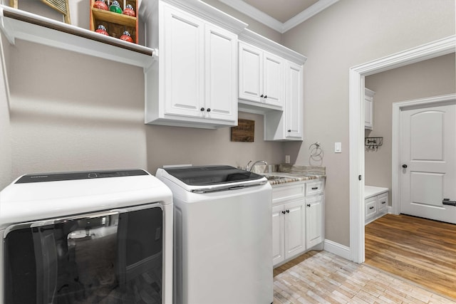 10309 Creekside Ln, Waco, TX 76712 - laundry area with ornamental molding, cabinet space, washer and dryer, and light wood-type flooring