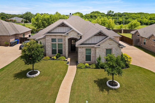 10309 Creekside Ln, Waco, TX 76712 - view of front of home with board and batten siding, brick siding, stone siding, and roof with shingles