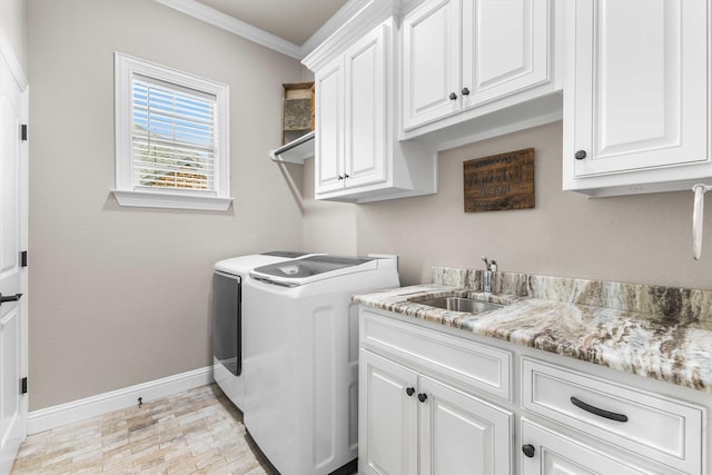 10309 Creekside Ln, Waco, TX 76712 - laundry area featuring separate washer and dryer, cabinet space, and ornamental molding