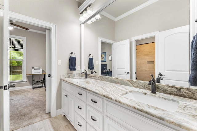 10309 Creekside Ln, Waco, TX 76712 - bathroom featuring double vanity, ornamental molding, a ceiling fan, and wood finished floors