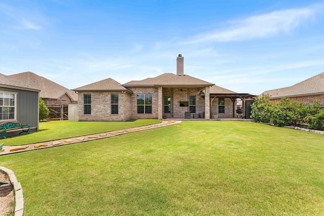 10309 Creekside Ln, Waco, TX 76712 - back of house featuring brick siding, a chimney, a patio area, and ceiling fan