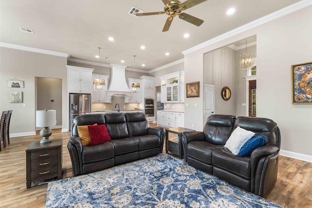 10309 Creekside Ln, Waco, TX 76712 - living area featuring ceiling fan, light wood-style floors, ornamental molding, recessed lighting, and a chandelier