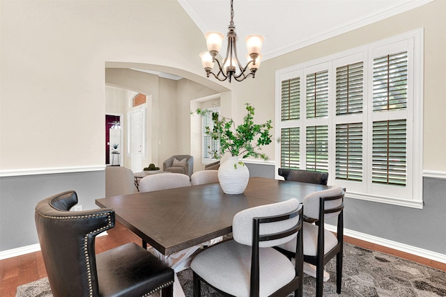 5405 Enfield Dr, Richardson, TX 75082 - dining area featuring ornamental molding, a chandelier, arched walkways, wood finished floors, and healthy amount of natural light