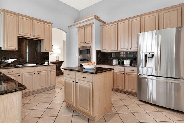 5405 Enfield Dr, Richardson, TX 75082 - kitchen with appliances with stainless steel finishes, light brown cabinets, light tile patterned floors, and arched walkways