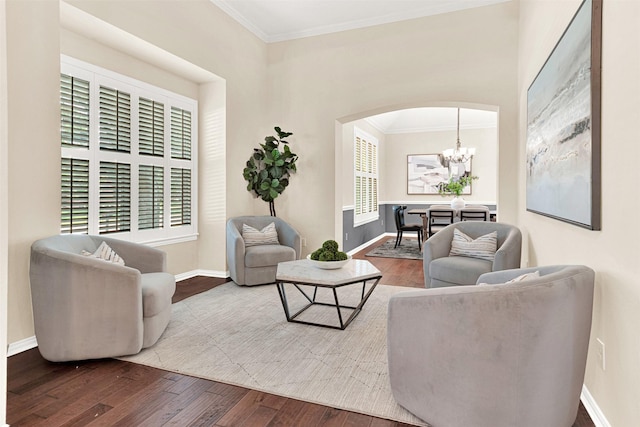 5405 Enfield Dr, Richardson, TX 75082 - living area featuring crown molding, wood finished floors, a chandelier, and arched walkways